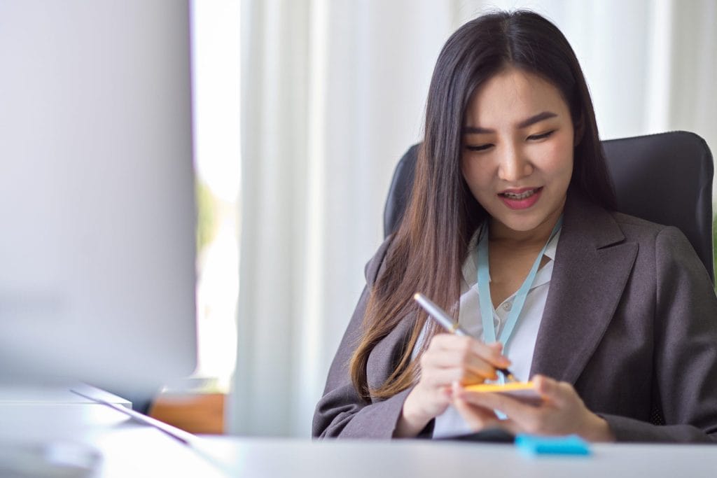 businesswoman-working-office-scaled - Legal Money Lender Singapore - Money Lender Jurong - OT Credit Pte Ltd